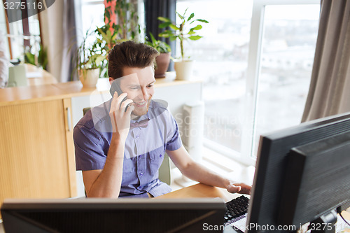 Image of happy creative male worker calling on smarphone