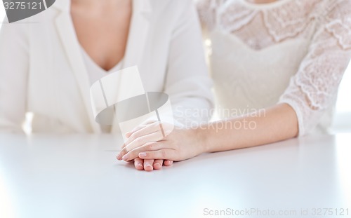 Image of close up of happy married lesbian couple hands