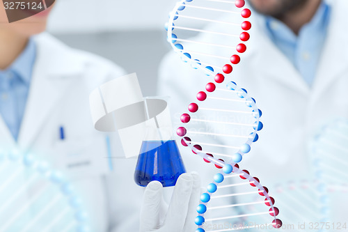 Image of close up of scientists with test tube in lab