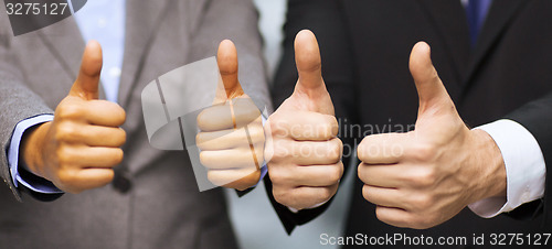 Image of businessman and businesswoman showing thumbs up