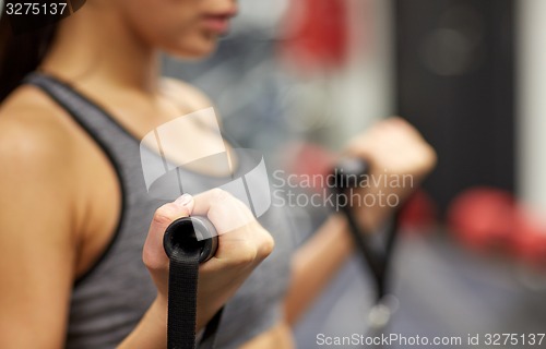 Image of close up of woman exercising on gym machine