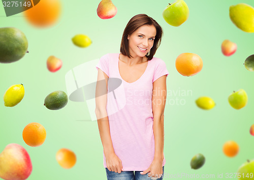 Image of happy woman in blank white t-shirt over fruits