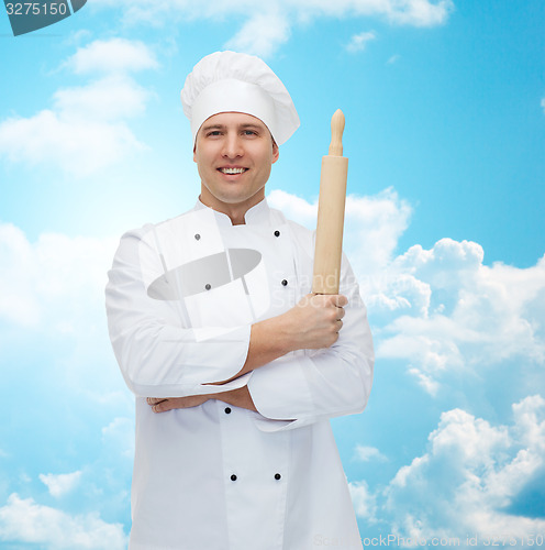 Image of happy male chef cook holding rolling pin
