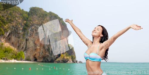Image of happy woman in bikini swimsuit with raised hands