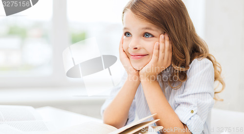 Image of student girl writing in notebook at school