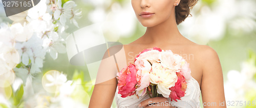 Image of bride or woman with bouquet of flowers