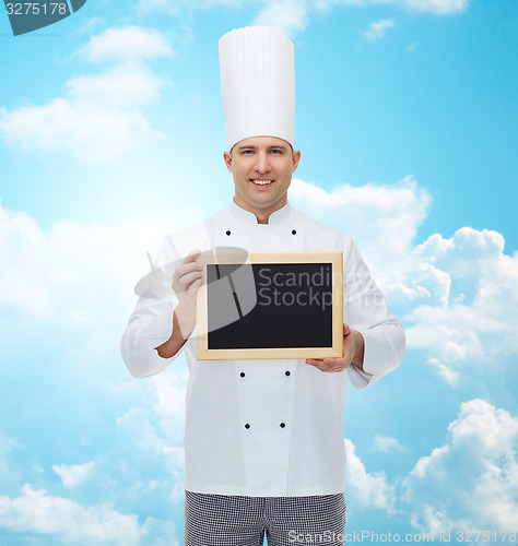 Image of happy male chef cook holding blank menu board