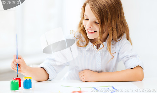 Image of little girl painting at school