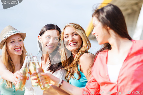 Image of girls with drinks on the beach