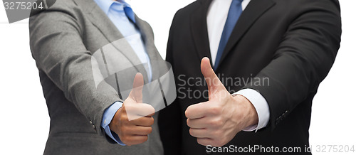 Image of businessman and businesswoman showing thumbs up