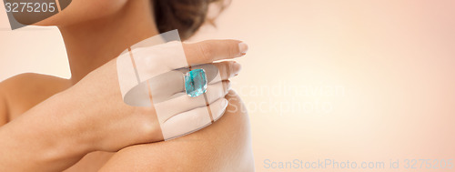 Image of close up of woman with cocktail ring on hand