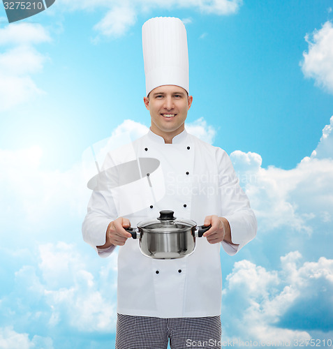 Image of happy male chef cook holding pot