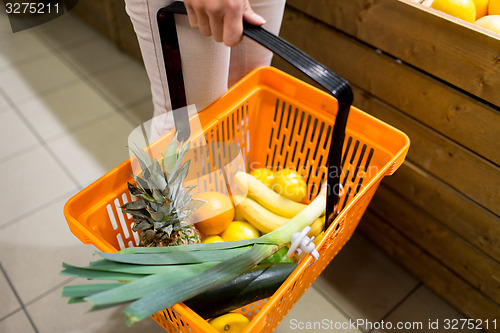 Image of close up of woman with food basket in market