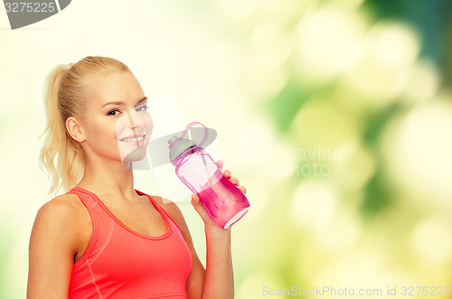 Image of smiling sporty woman with water bottle