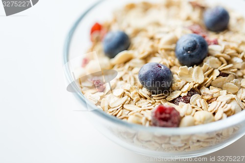 Image of close up of bowl with granola or muesli on table