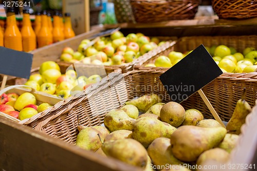 Image of fruits in baskets with nameplates at food market