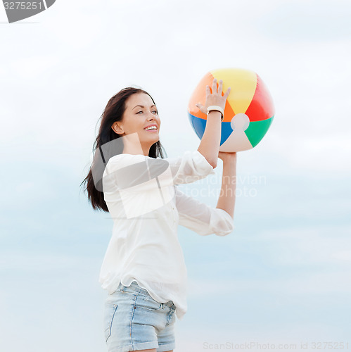 Image of girl with ball on the beach