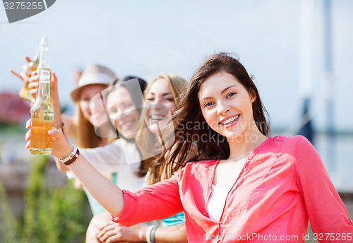 Image of girls with drinks on the beach