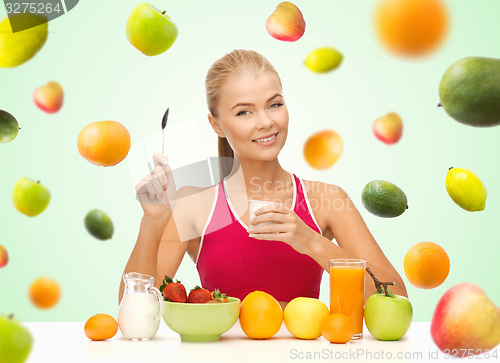 Image of woman eating yogurt and having healthy breakfast