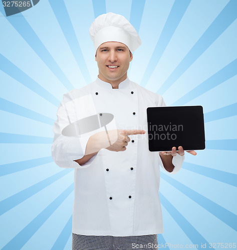 Image of happy male chef cook showing with tablet pc