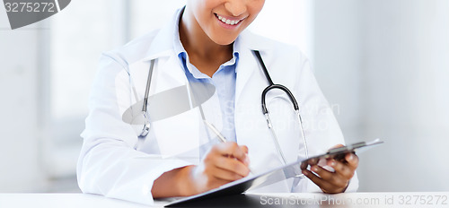 Image of female doctor writing prescription