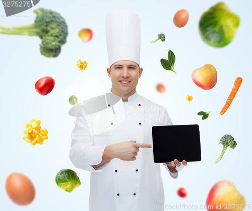 Image of happy male chef cook showing with tablet pc