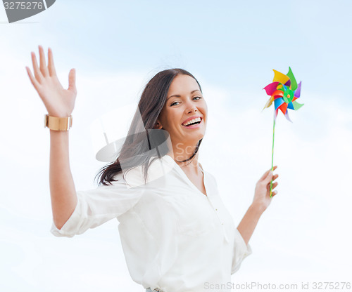 Image of girl with windmill toy on the beach