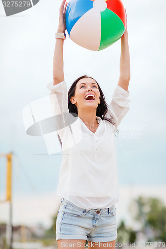 Image of girl playing ball on the beach