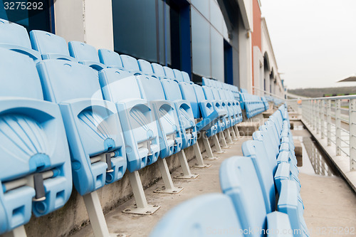 Image of rows with folded seats of bleachers on stadium