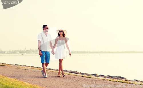 Image of smiling couple walking outdoors