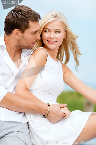 Image of smiling couple at sea side