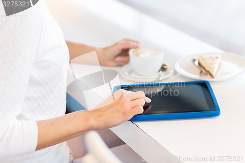 Image of close up of woman with tablet pc drinking coffee