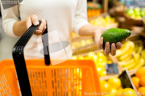 Image of close up of woman with food basket in market