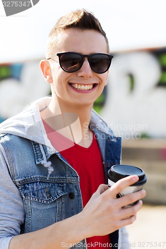 Image of smiling young man or boy drinking coffee