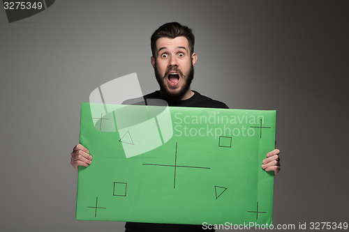 Image of The surprised man as businessman with green panel