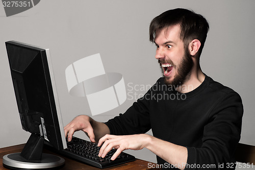 Image of Funny and crazy man using a computer