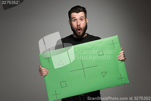 Image of The surprised man as businessman with green panel