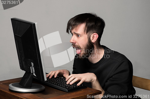 Image of Funny and crazy man using a computer