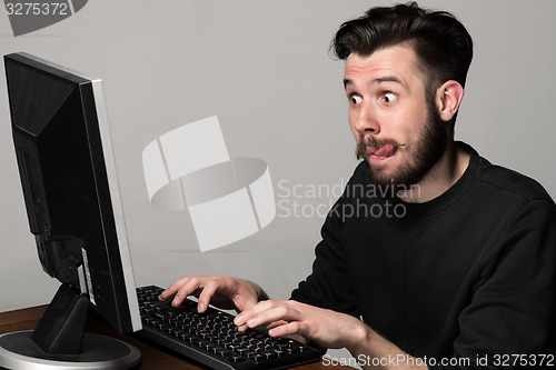 Image of Funny and crazy man using a computer