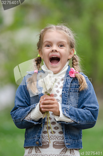 Image of Six year old girl with dandelions fun smiling