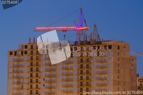 Image of View after sunset on the unfinished house with a crane