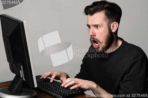 Image of Funny and crazy man using a computer