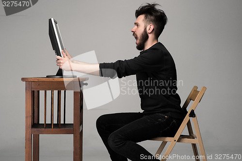 Image of Funny and crazy man using a computer