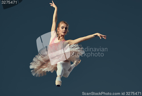 Image of Beautiful female ballet dancer on a grey background. 