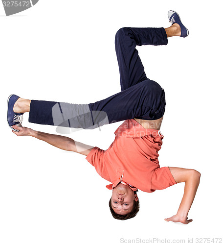 Image of Break dancer doing one handed handstand against a white background