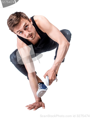 Image of Break dancer doing one handed handstand against a white background