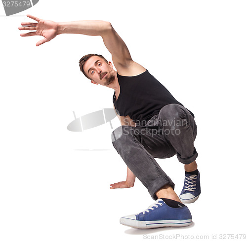 Image of Break dancer doing one handed handstand against a white background