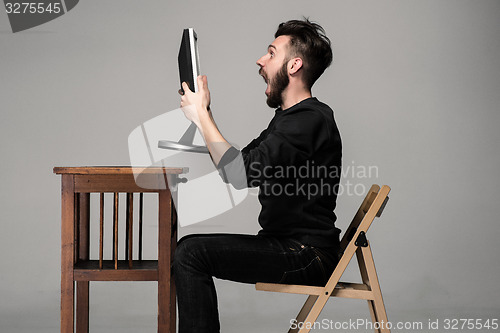 Image of Funny and crazy man using a computer