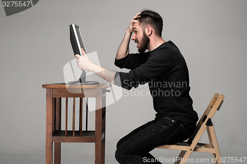 Image of Funny and crazy man using a computer