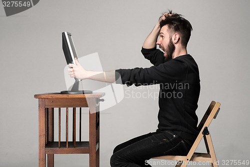 Image of Funny and crazy man using a computer